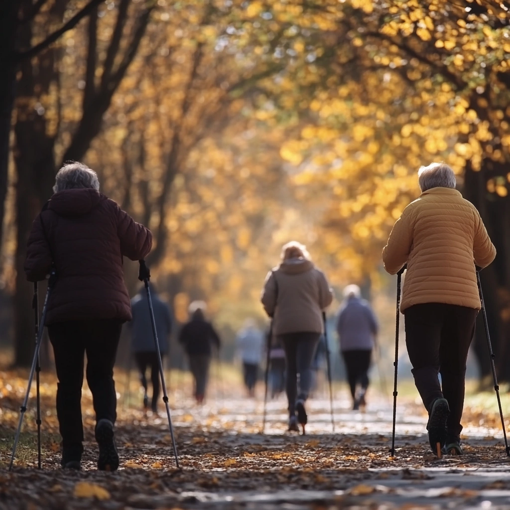 Пенсіонери займаються скандинавською ходьбою в парку